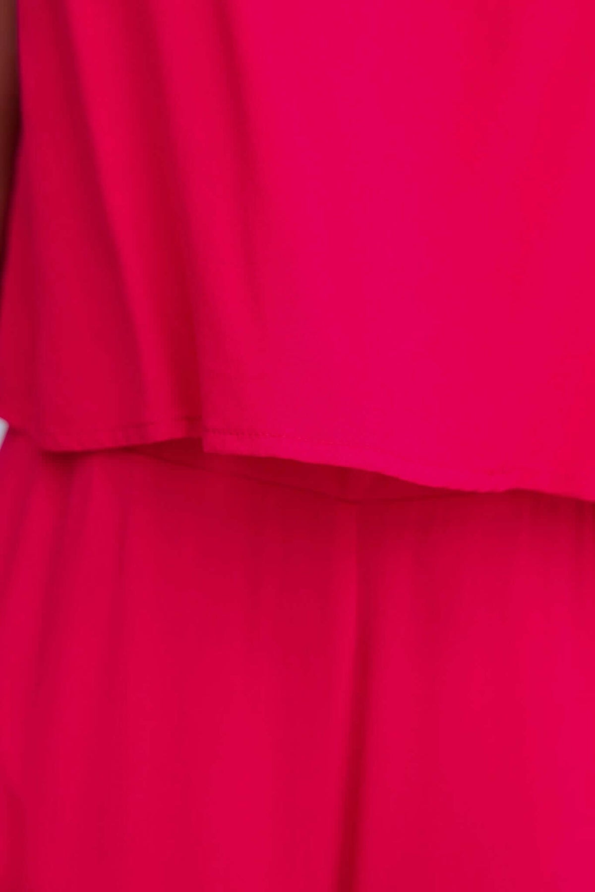 Close-up of the vibrant pink Verko Jumpsuit showcasing the relaxed fit and flowing material.
