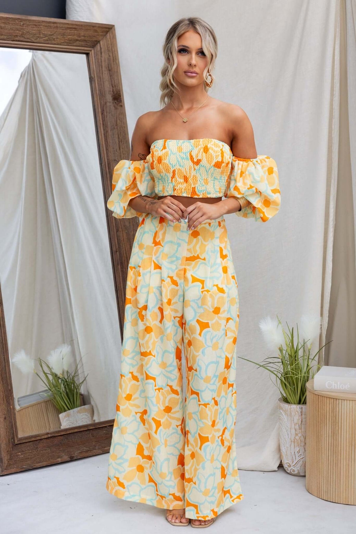 Model wearing the Olessia Set, featuring an elastic bodice and mid-high waist pants in a floral pattern.