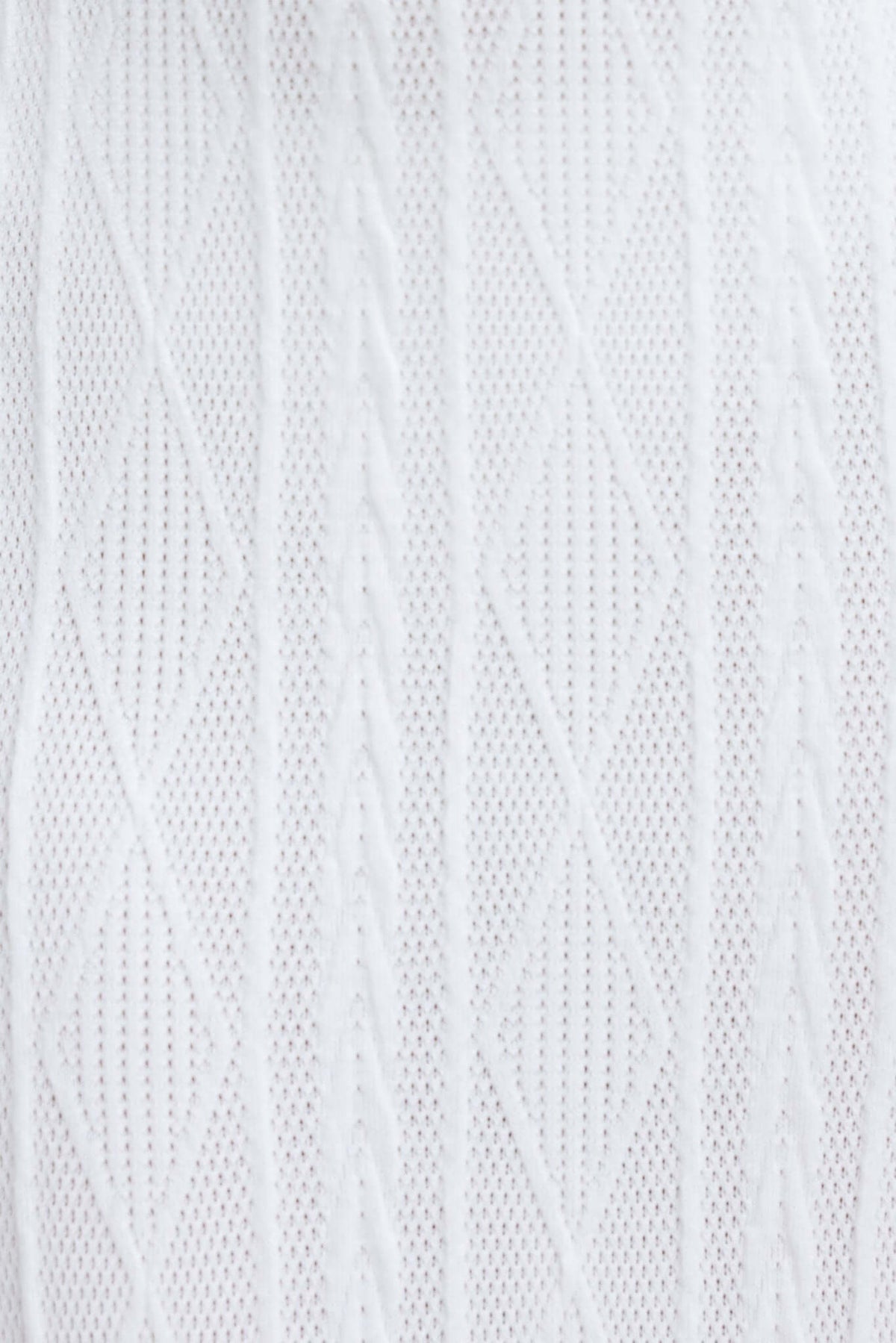 Close-up of white knit fabric featuring a diamond pattern, highlighting its texture and stretch suitability for various designs.