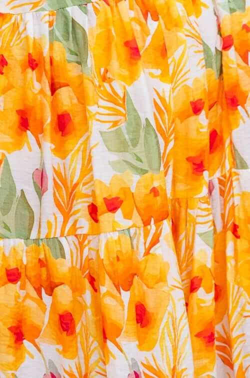 Close-up of orange and yellow floral fabric, showcasing the vibrant pattern of the Kohana Maxi Dress.