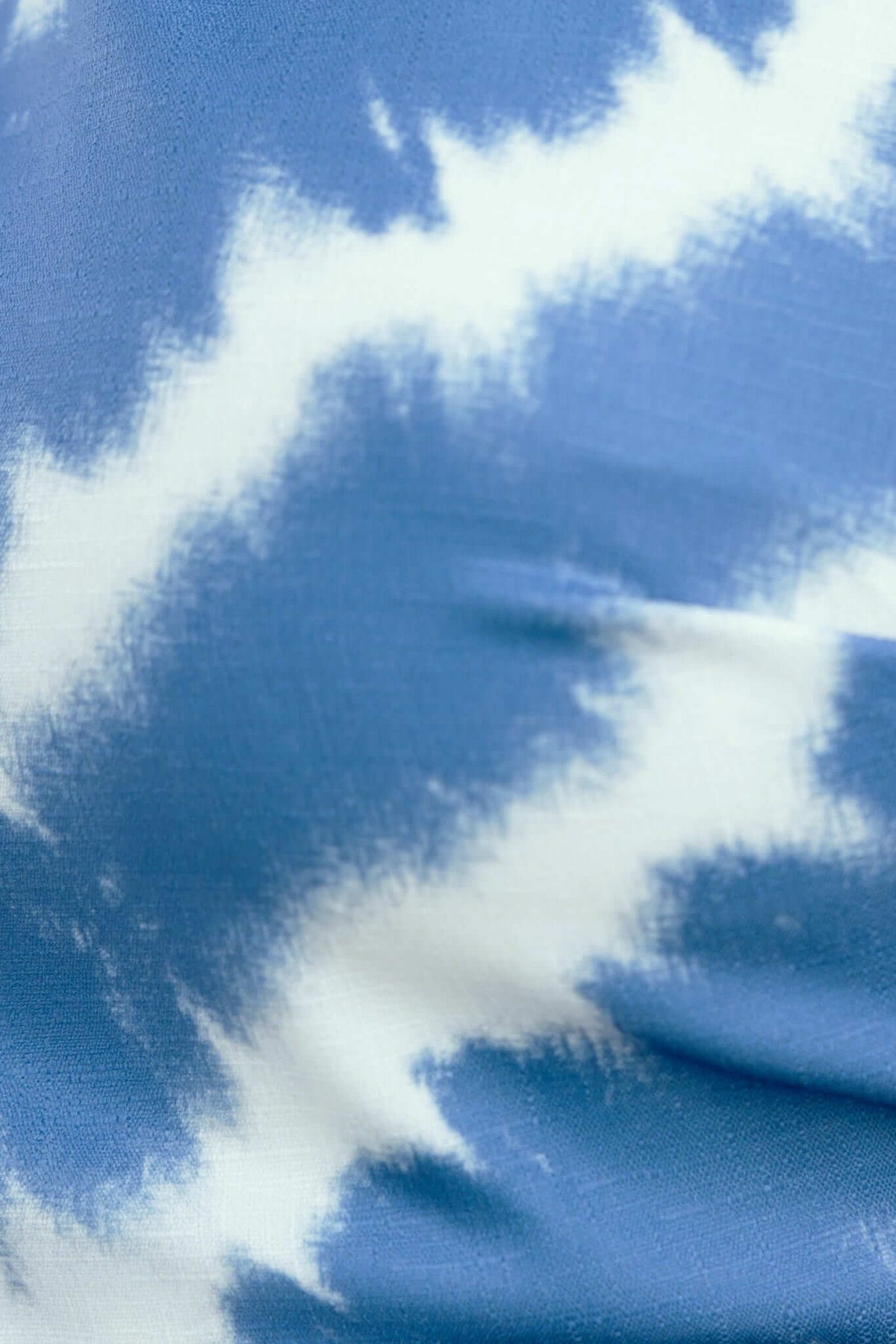 Close-up of blue and white tie-dye fabric, featuring soft textures perfect for the Lauraine Midi Dress.
