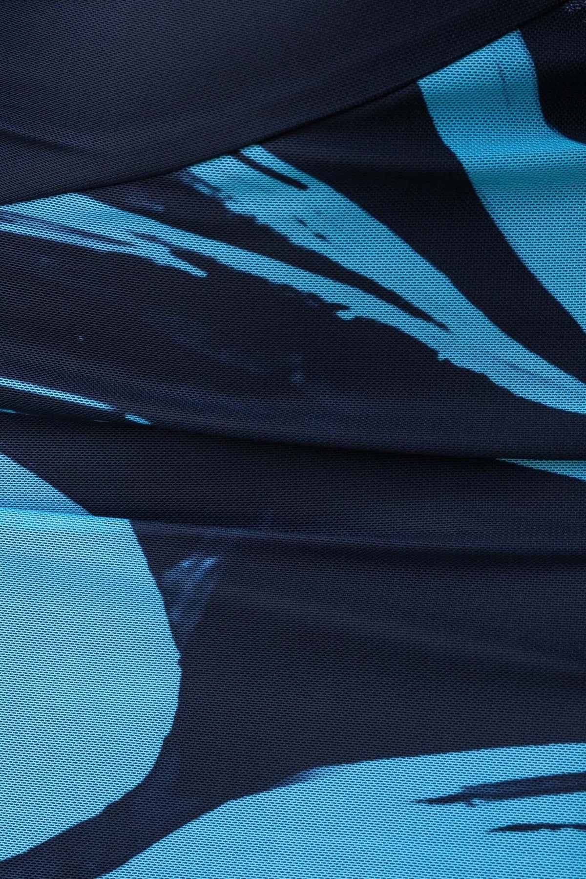 Close-up of Ovolo Maxi Dress fabric featuring a striking blue abstract design and textured detail.