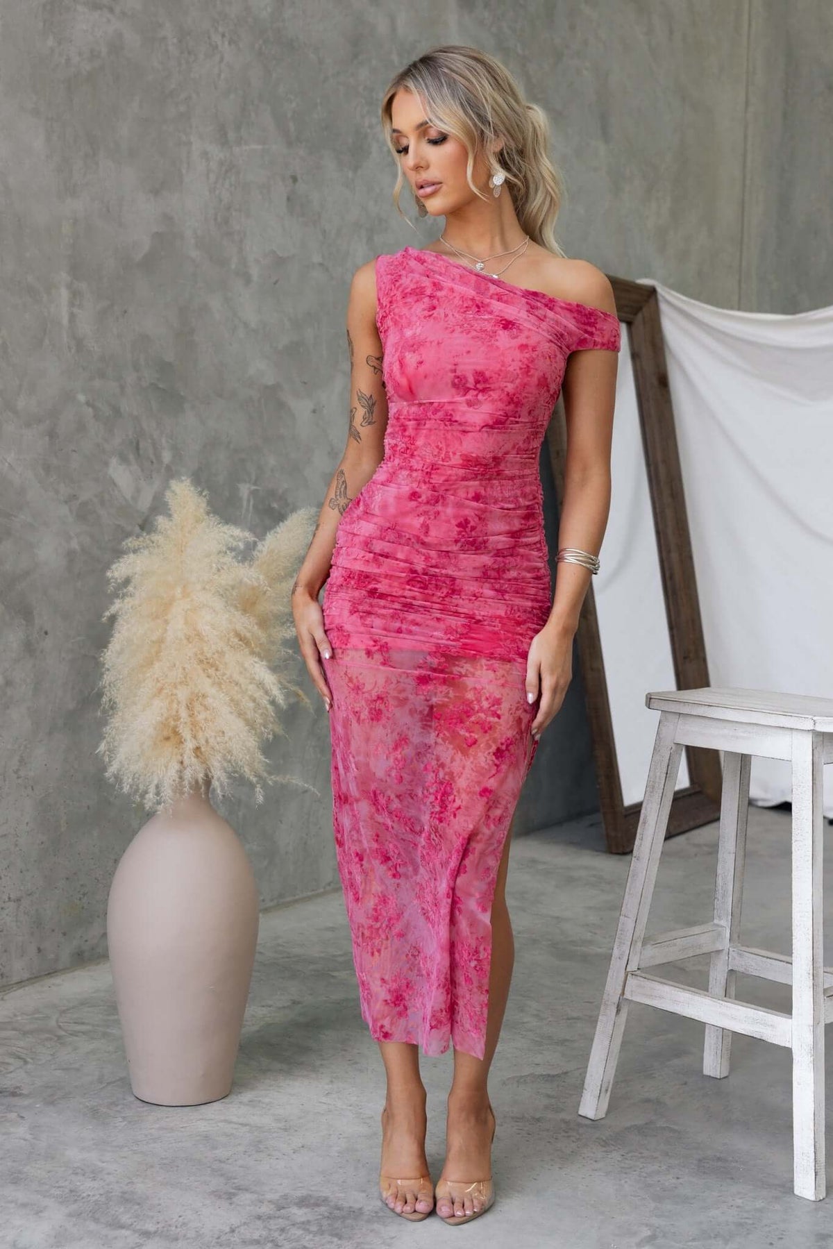 Pink Marino Maxi Dress featuring an asymmetric neckline, mesh material, and side split, styled with nude heels.