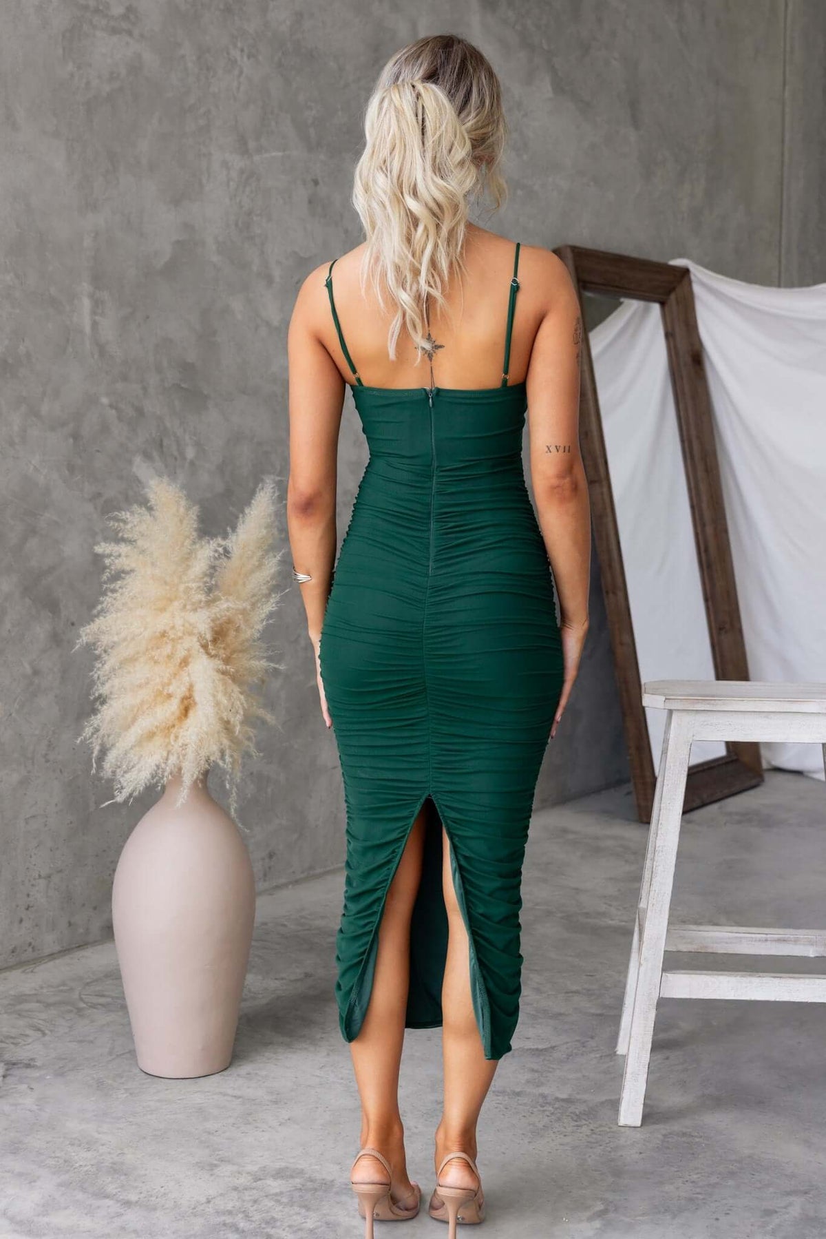 Back view of a green Overboard Midi Dress featuring adjustable straps and a stylish back split.