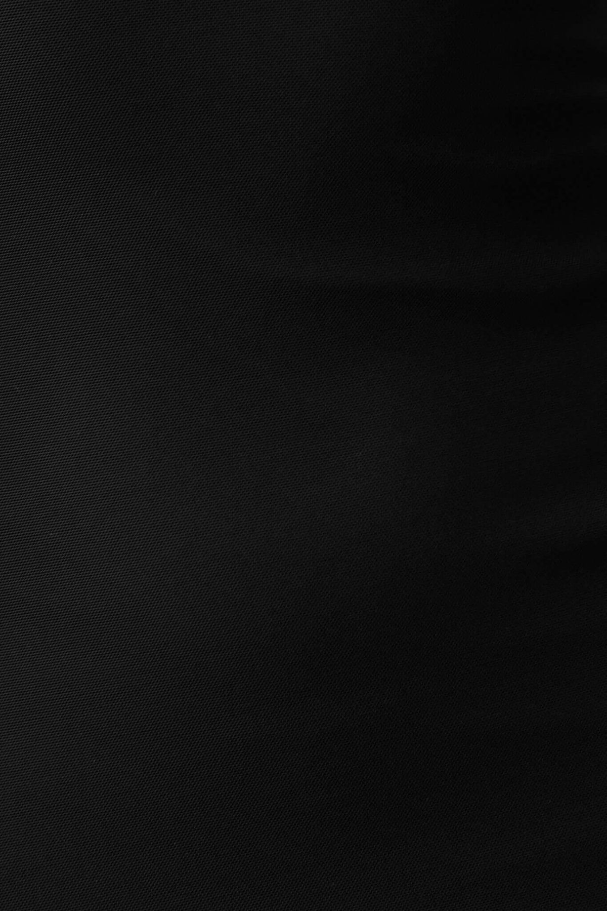 Close-up of black fabric texture, showcasing the smooth and stretchable material of the Nephrite Maxi Dress.