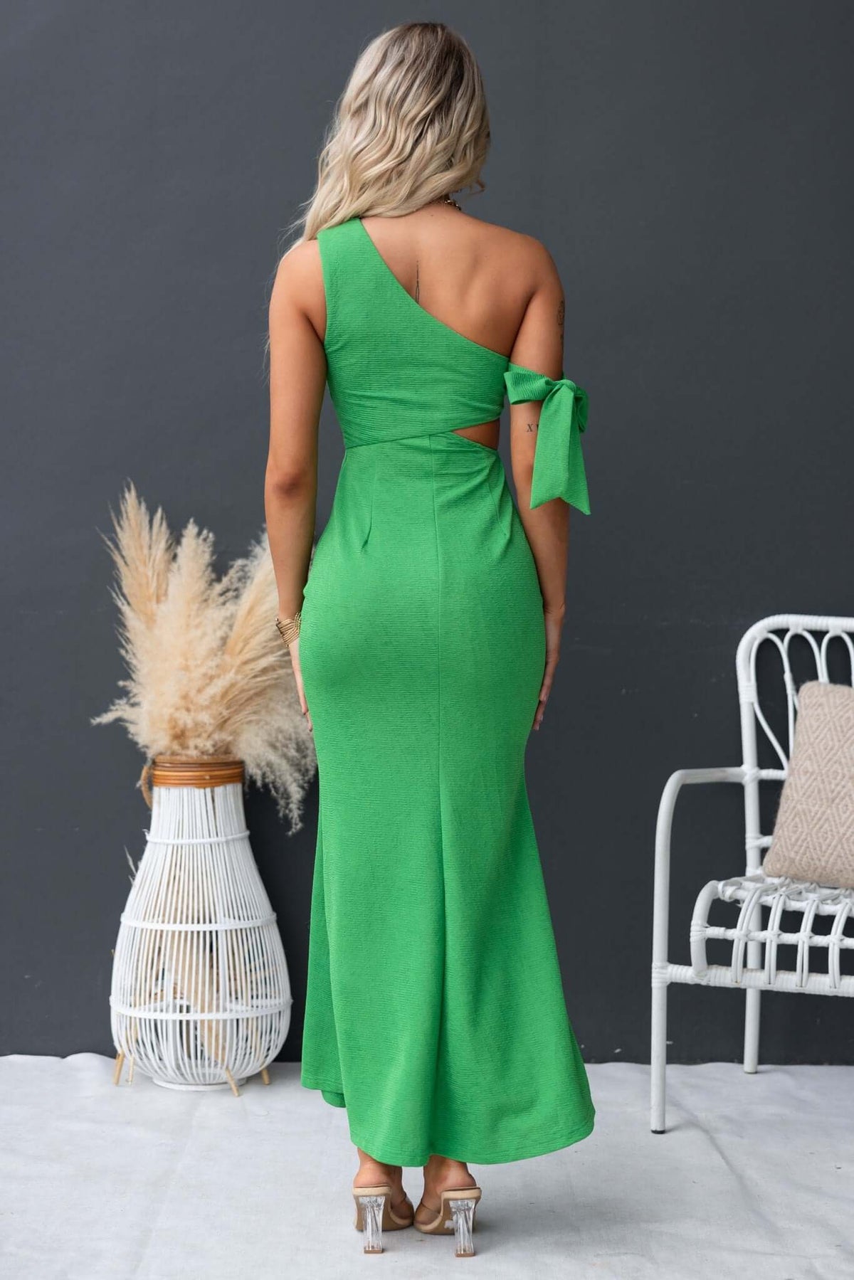 Malian maxi dress in green with one-shoulder neckline and cut-out waist, styled for a chic look.
