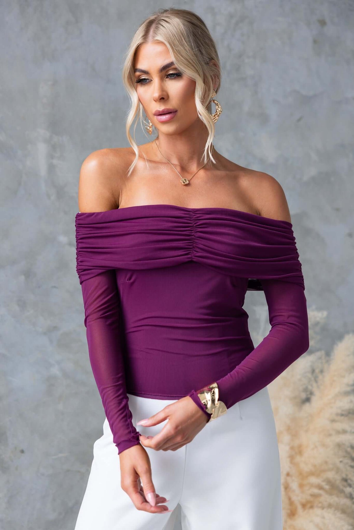 Stylish off-shoulder Arcanna Top in deep purple, featuring a fitted design and stretch material, perfect for any occasion.