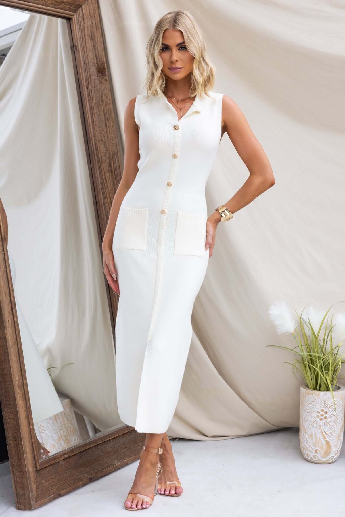 Elegant Bari Maxi Dress with high neckline, faux buttons, pockets, and front split in cream color.