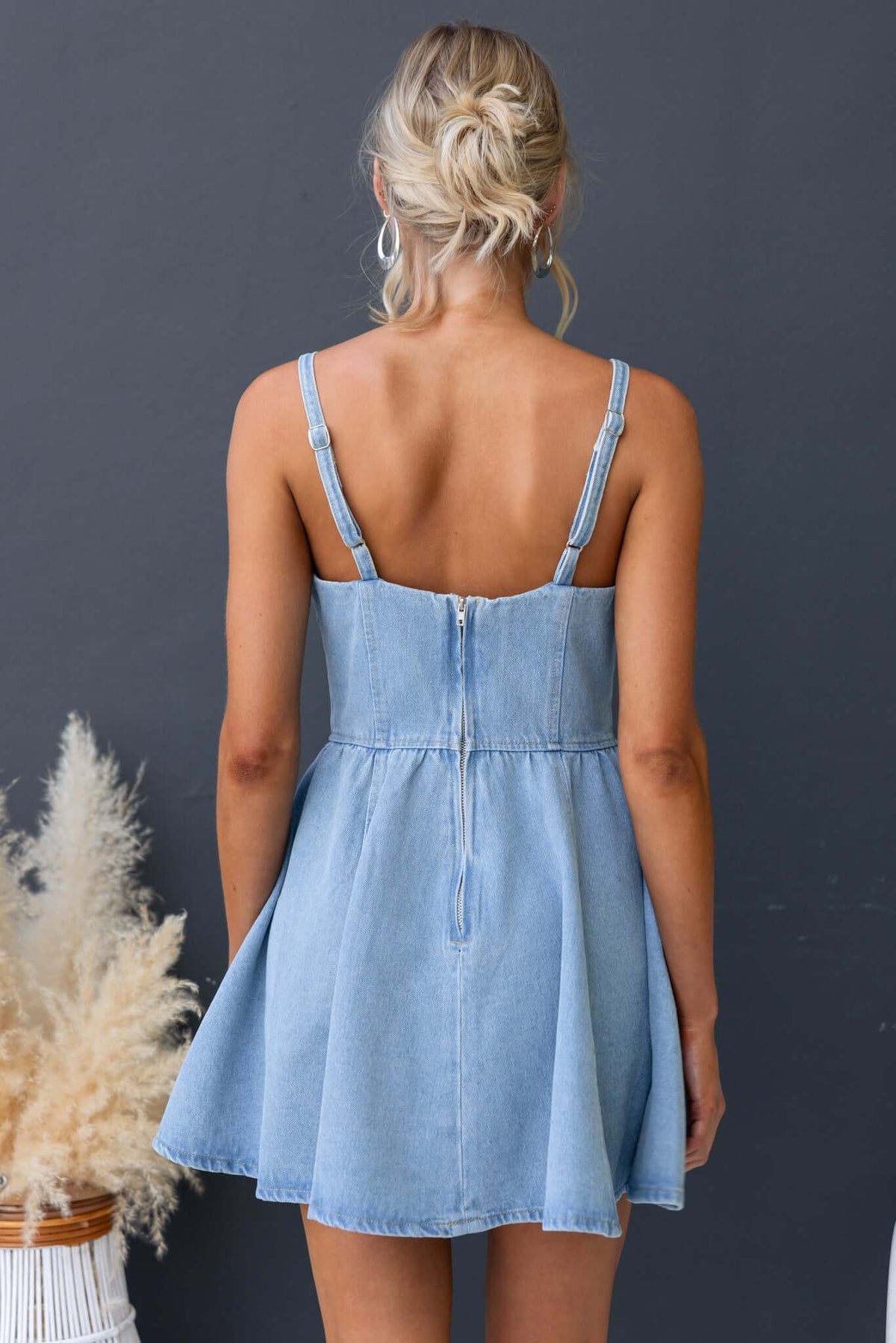 Bestie Denim Dress with adjustable straps and zip at back, showcasing a relaxed fit and pockets, in light blue denim.