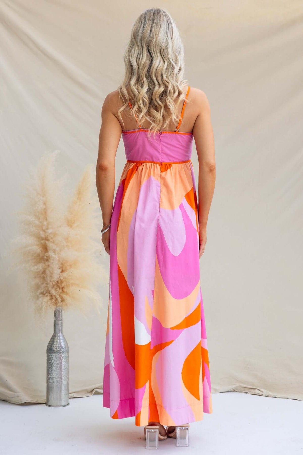 Back view of Brantley Maxi Dress with colorful patterns, adjustable straps, and elegant fit showcasing a stylish summer look.