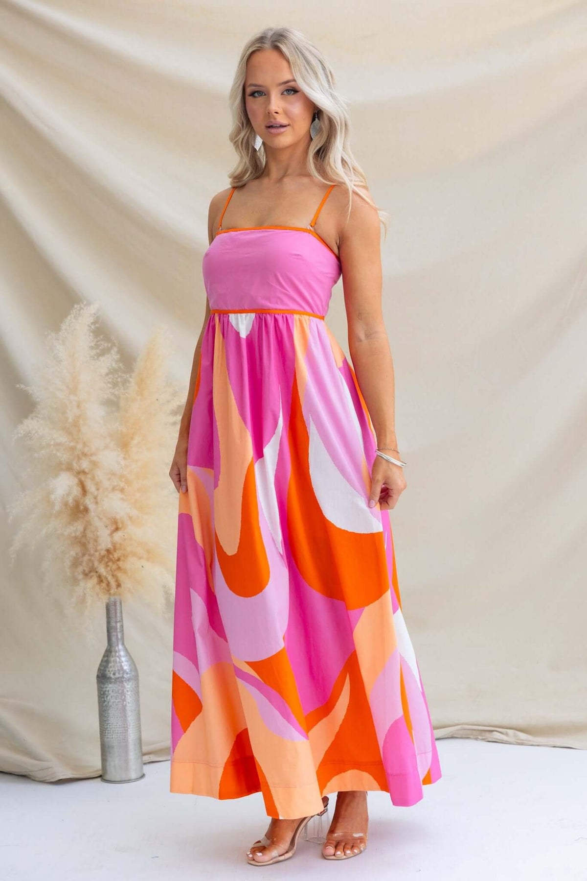 Brantley Maxi Dress featuring a vibrant pink and orange design, perfect for summer outings and casual events.