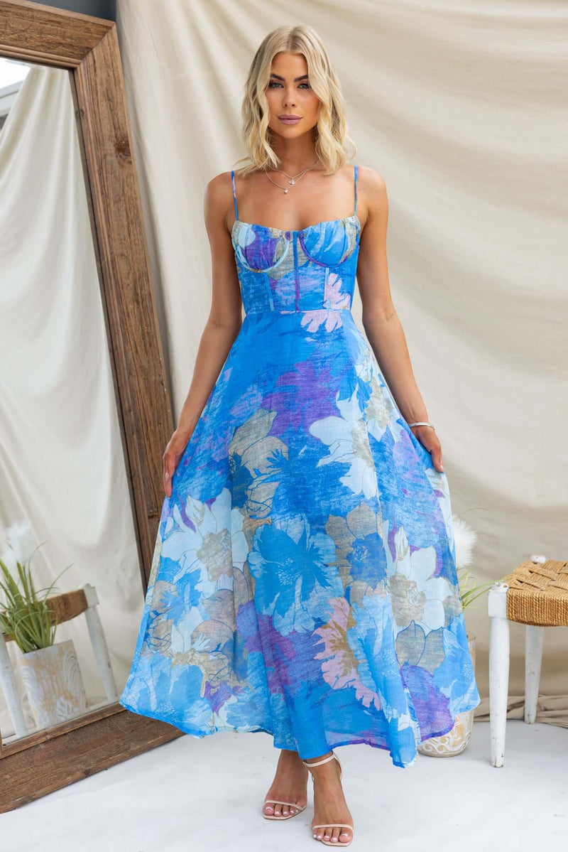 Burkes Midi Dress in blue floral design with adjustable tie straps and bust boning, model wearing size 6/XS.