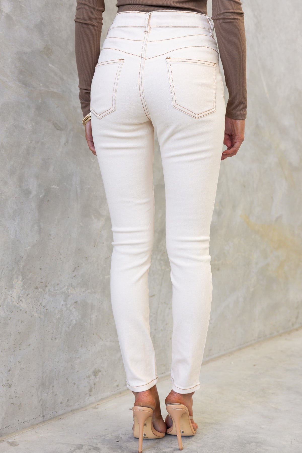 Back view of Caprice Jeans in cream, showcasing mid-high waist fit and skinny silhouette.