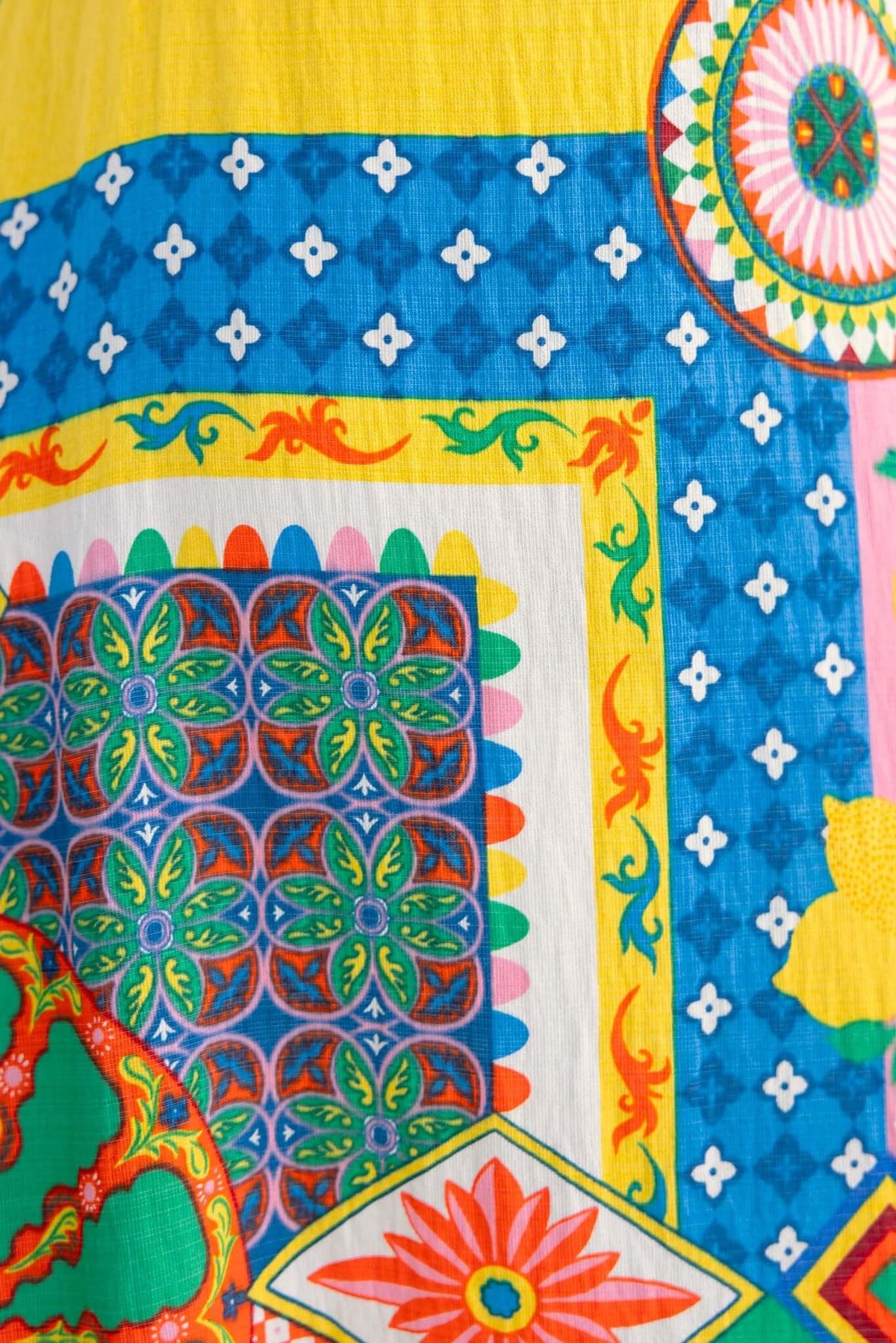 Colorful fabric print featuring vibrant patterns in blue, yellow, red, and green for the Salilah Maxi Dress.