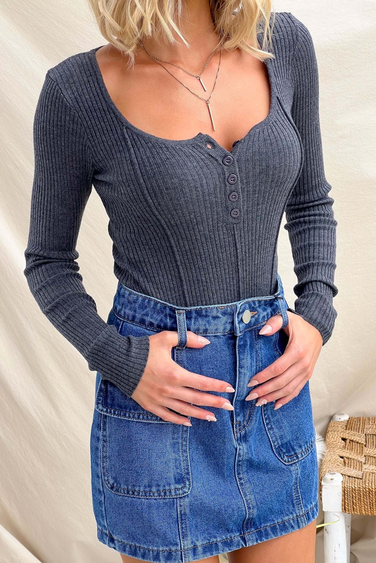 Draw Me In Top - Grey ribbed knit with round neckline, button-up bust, and tapered hem, paired with a denim skirt.