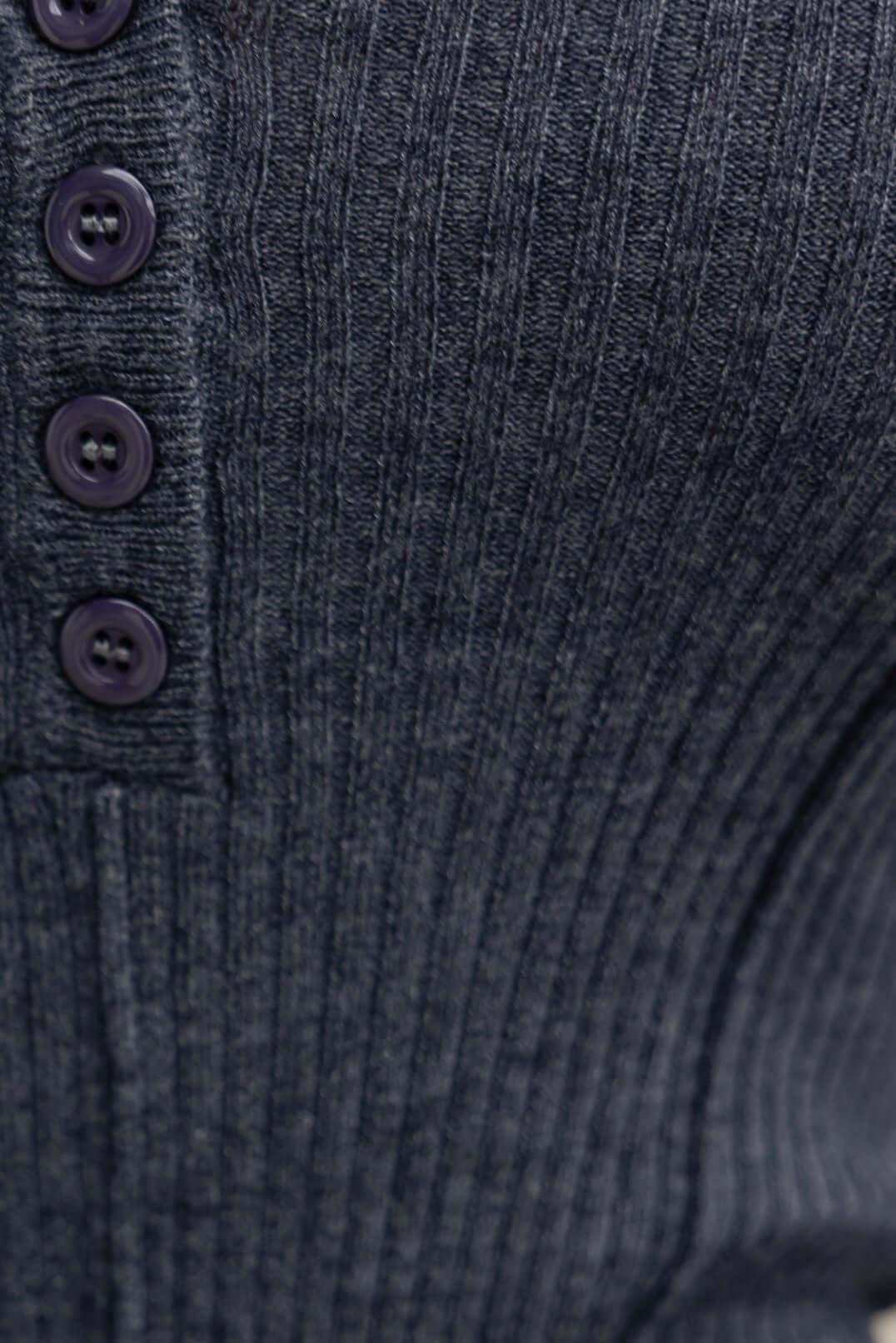 Close-up of Draw Me In Top showcasing round neckline, button-up detail, and ribbed knit material in dark color.