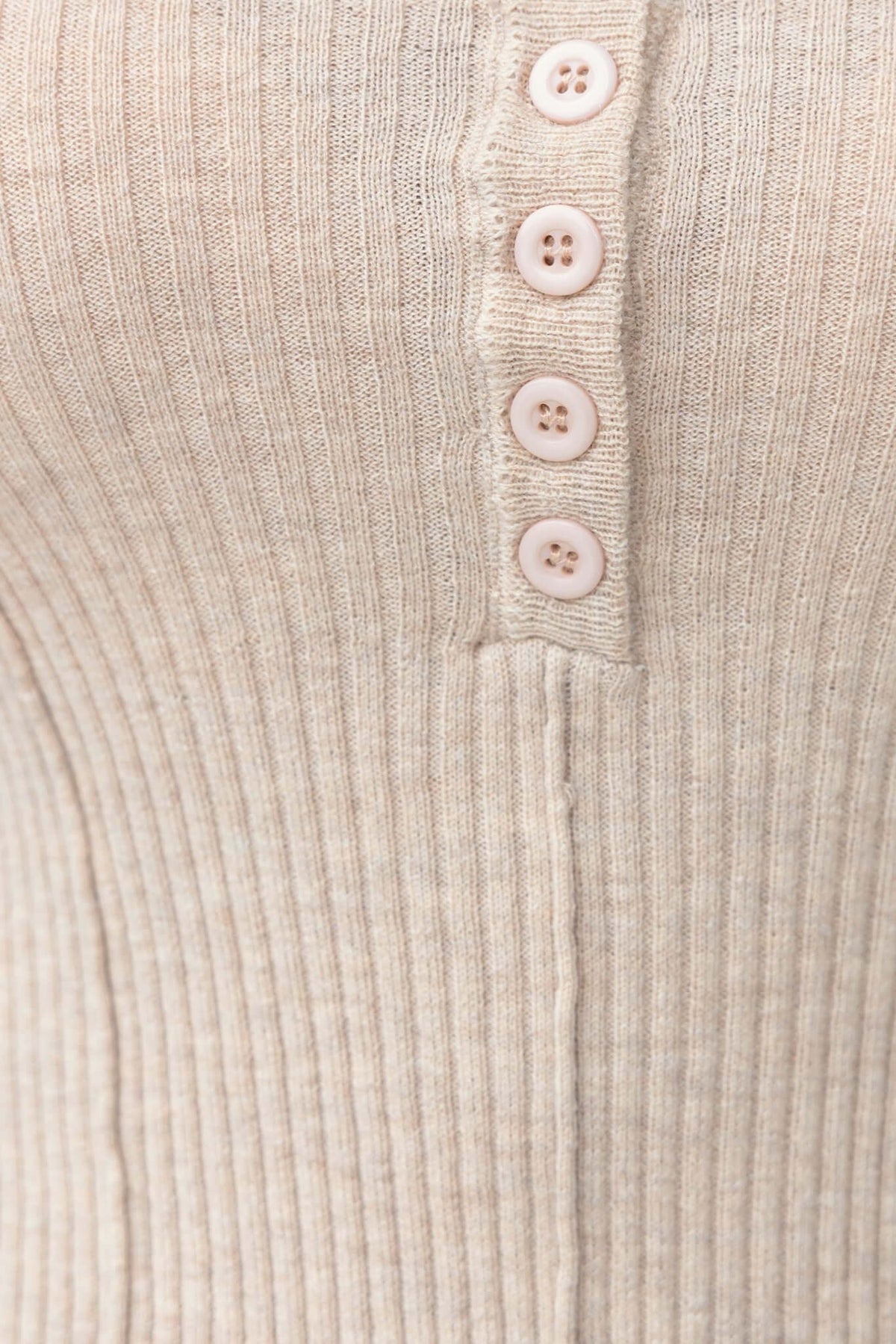 Close-up of the Draw Me In Top featuring round neckline and button-up detail in a soft knit ribbed fabric.