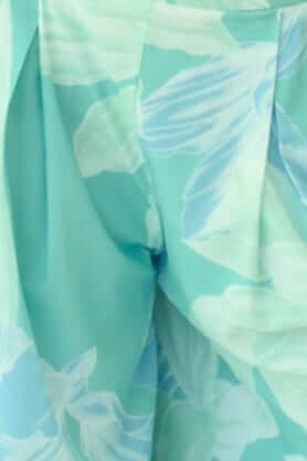 Close-up of New Haven Set pants showcasing floral print and pleats for a stylish look.