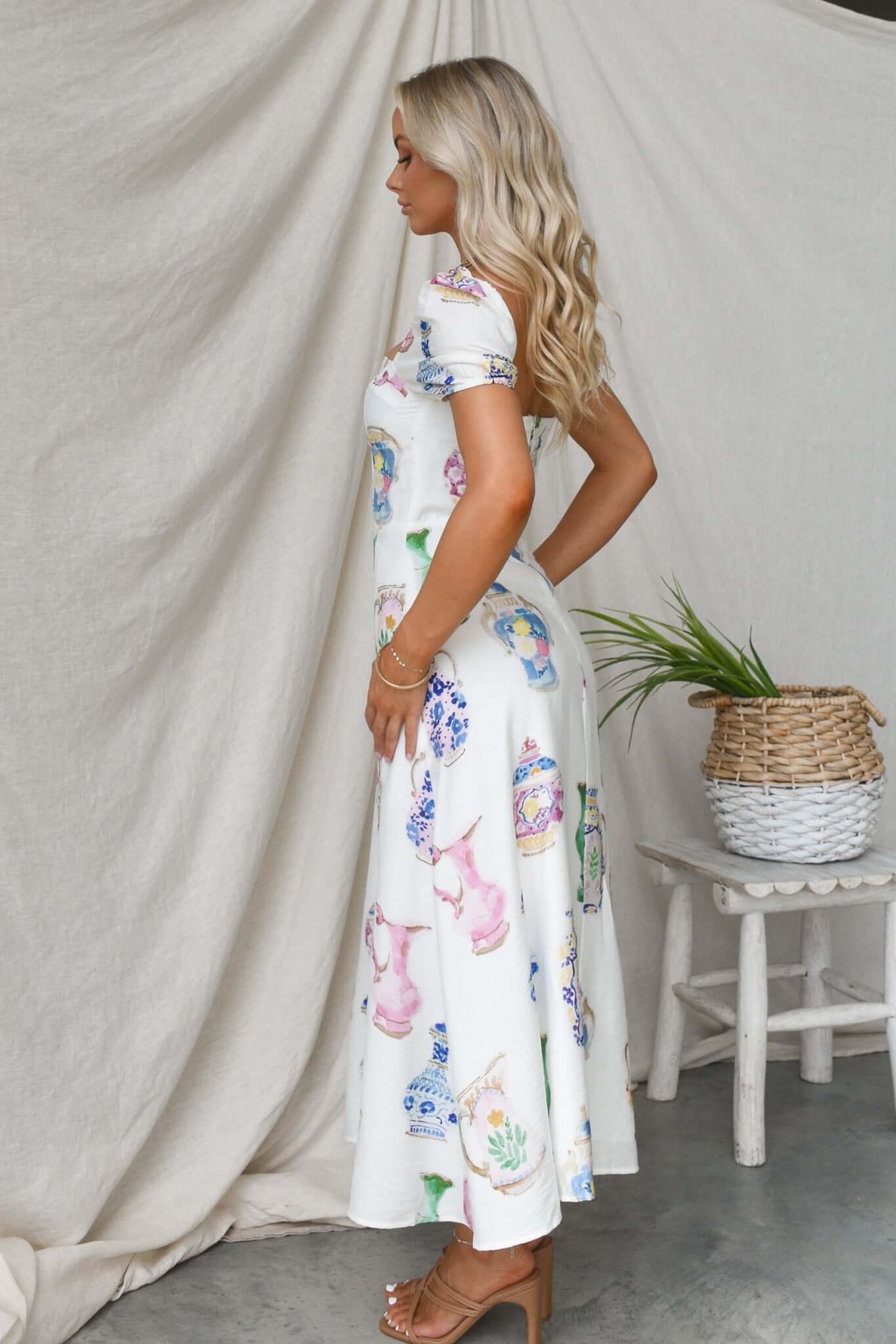 Side view of Keyser Midi Dress featuring colorful prints, elastic sleeves, and a stylish flowy silhouette.