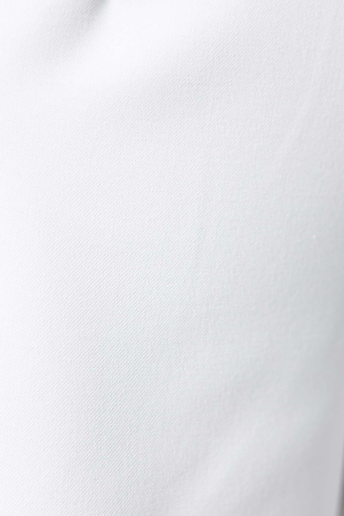Close-up of Edam Pants fabric showcasing smooth, non-stretch white material with mid-high waist fit.