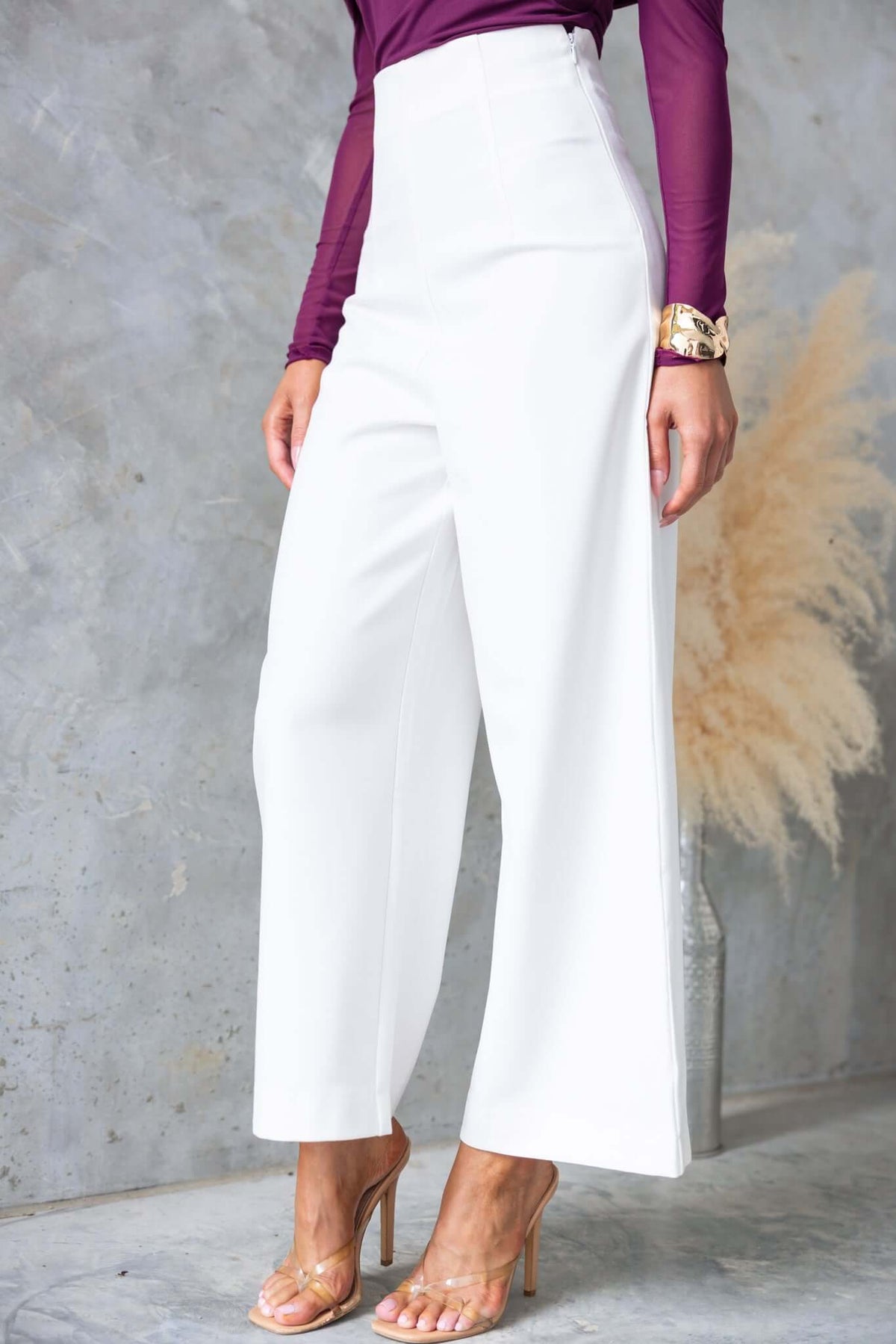 Edam Pants showcasing mid-high waist fit, side invisible zip, and non-stretch fabric, styled with a fitted top.
