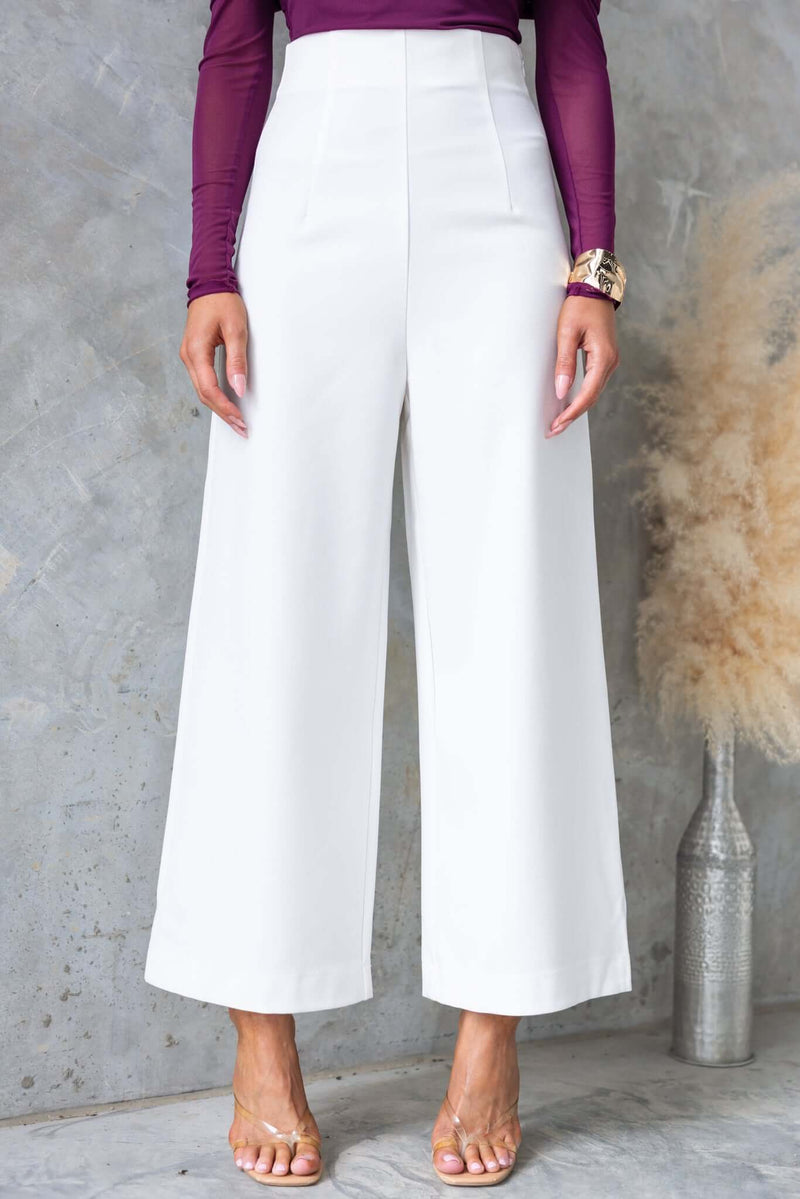 Edam Pants in white with mid-high waist fit and invisible side zip, styled with a purple top, ideal for chic outfits.