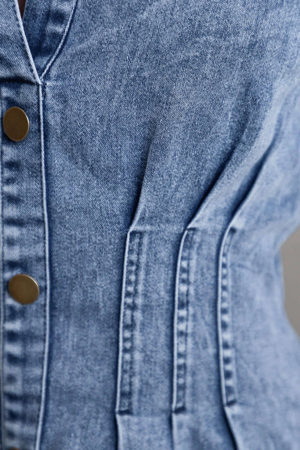 Close-up of Elidi Denim Dress showing collar and button details on soft, stretchy denim fabric.