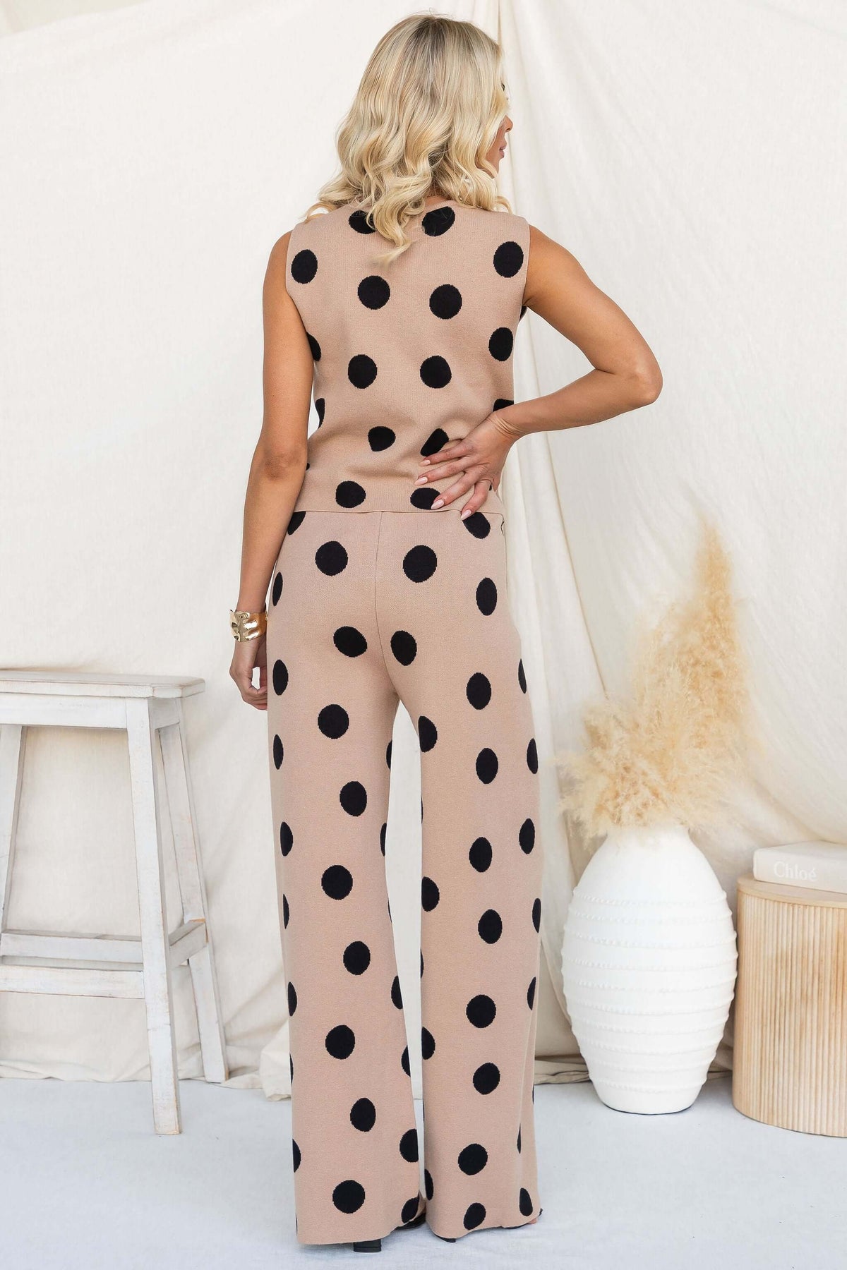 Elise Set featuring a sleeveless top and wide-leg pants in a beige fabric with black polka dots.