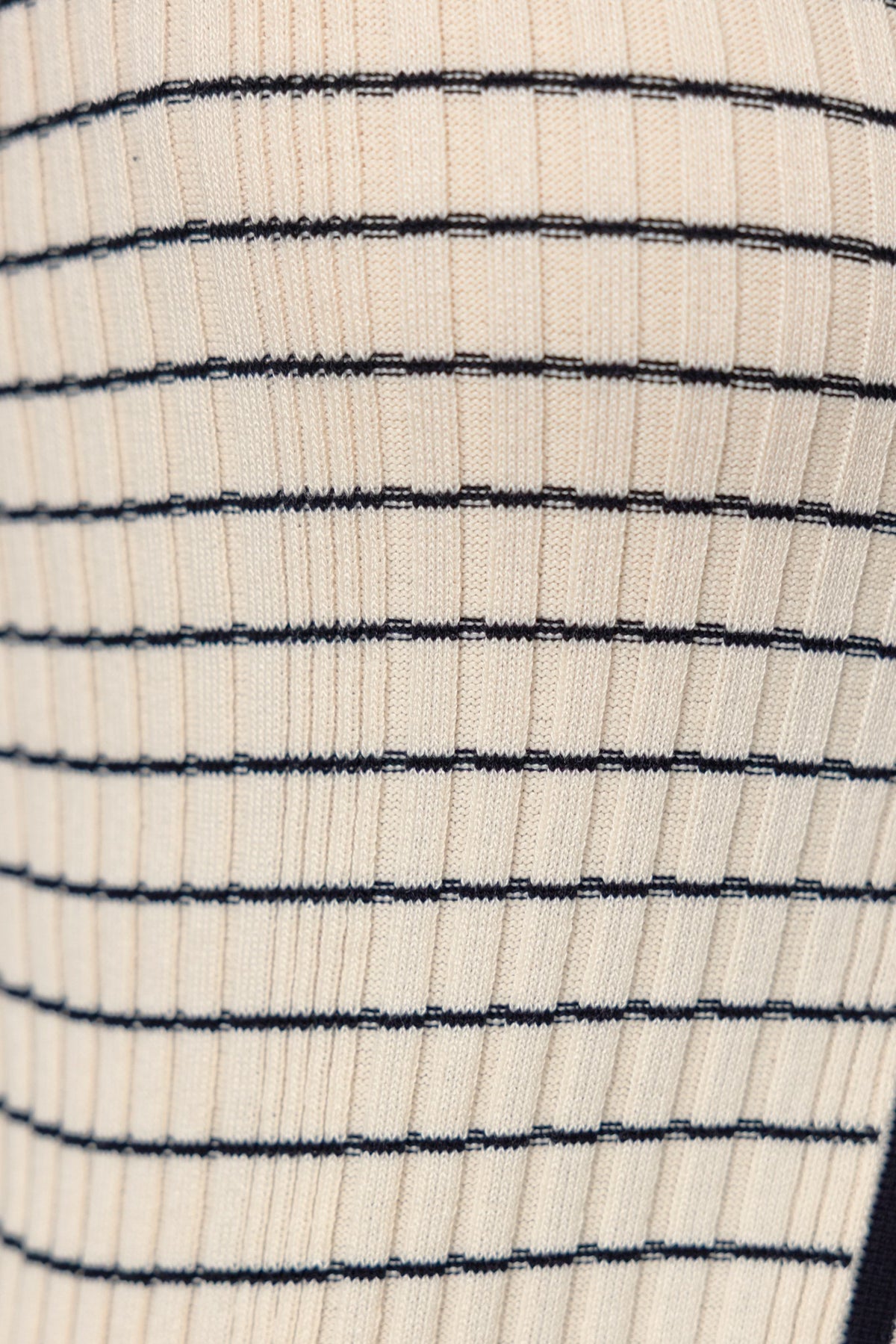 Close-up of the Escala Maxi Skirt, showcasing its knit fabric with cream and black stripes.