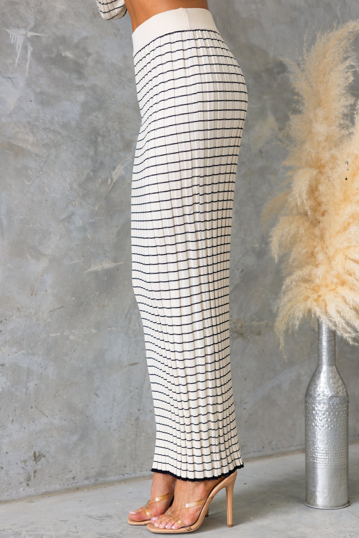 Escala Maxi Skirt featuring a mid-high waist, elastic waistband, and stretch knit material in a grid pattern.