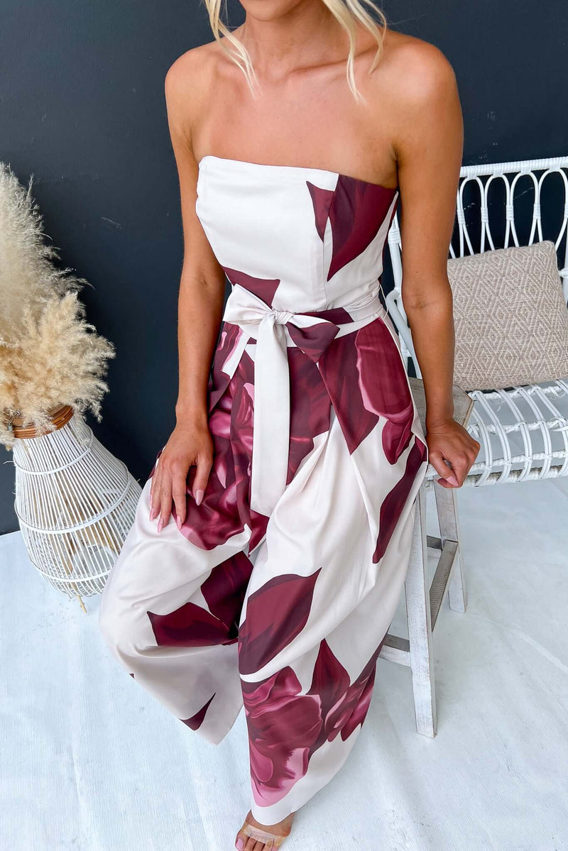 Evangeline strapless jumpsuit with floral print, removable tie, and non-stretch fabric, model wearing size 6/XS.