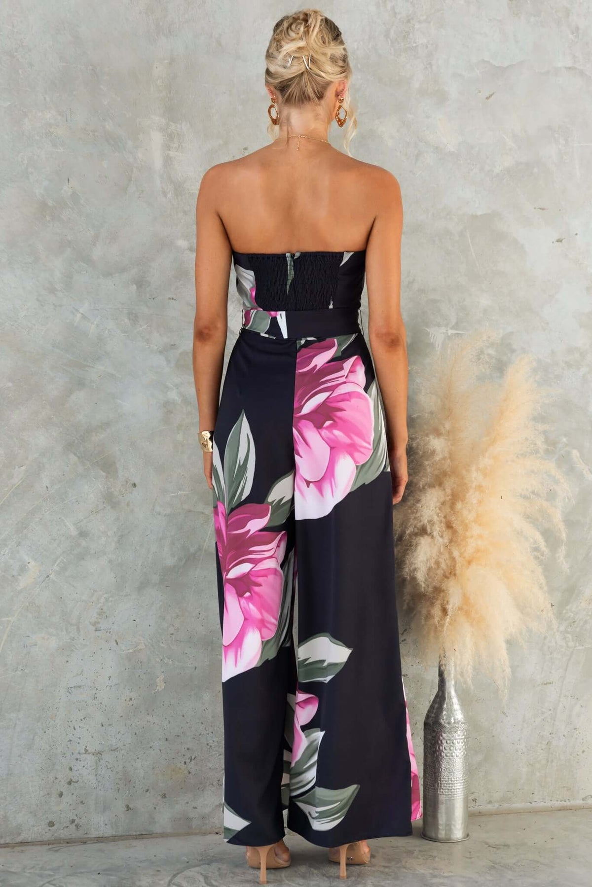 Evangeline Jumpsuit: strapless floral jumpsuit with boning, back zip, and removable tie, showcasing vibrant flower print.