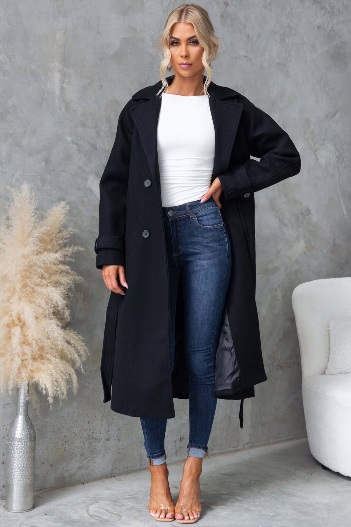 Farina Coat in black, featuring a longline fit, collar, button-up front, and stylish removable fabric tie.