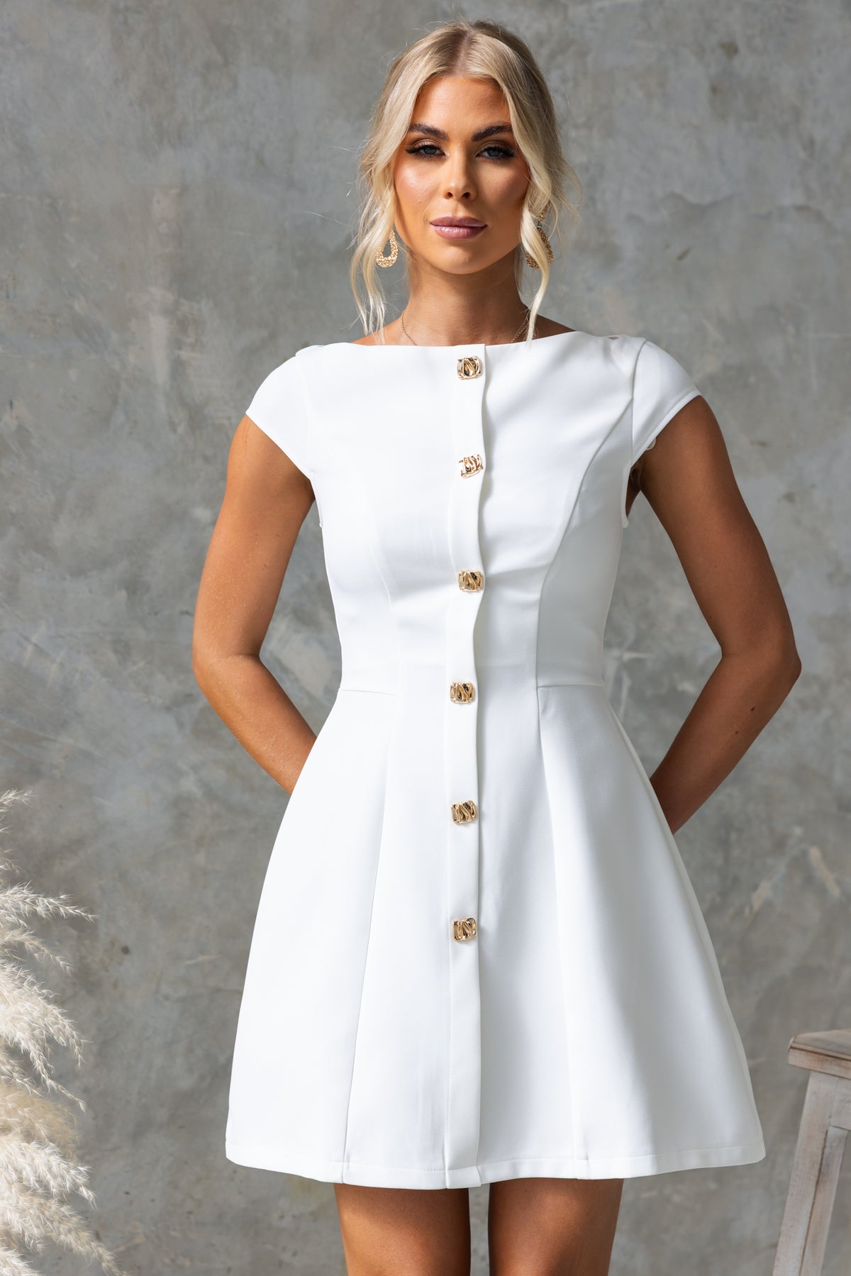 White Feist Dress with boat neckline, faux buttons, and a fitted silhouette, perfect for summer occasions.