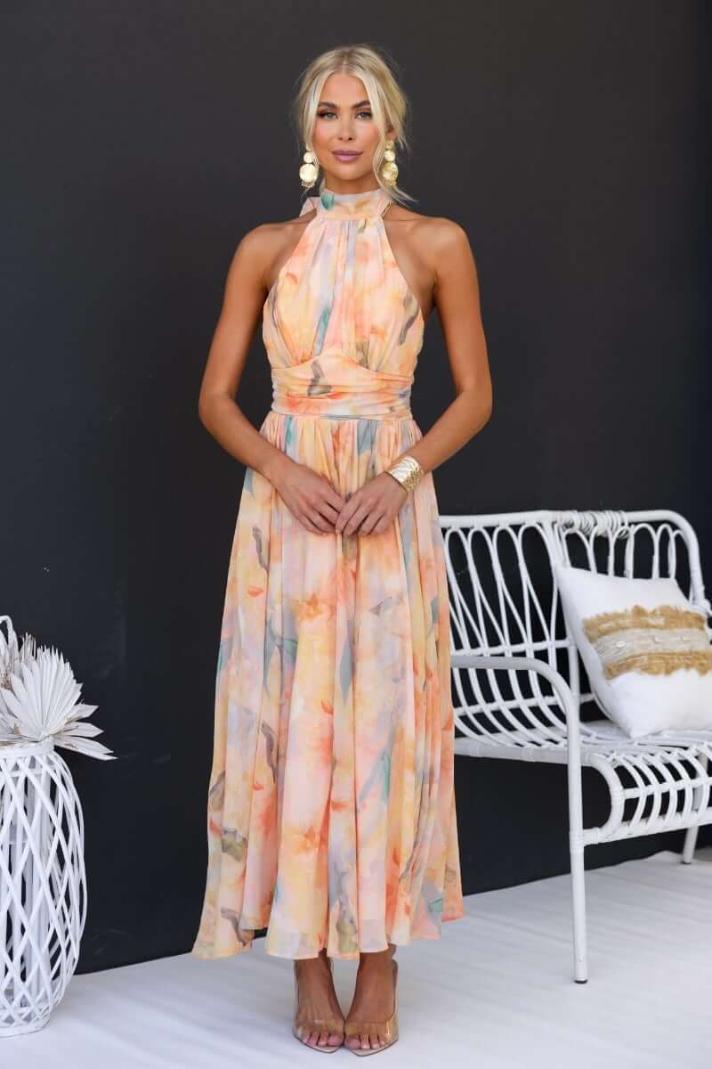 Floral print maxi dress with high tie neckline, model wearing dress, stylish summer outfit.