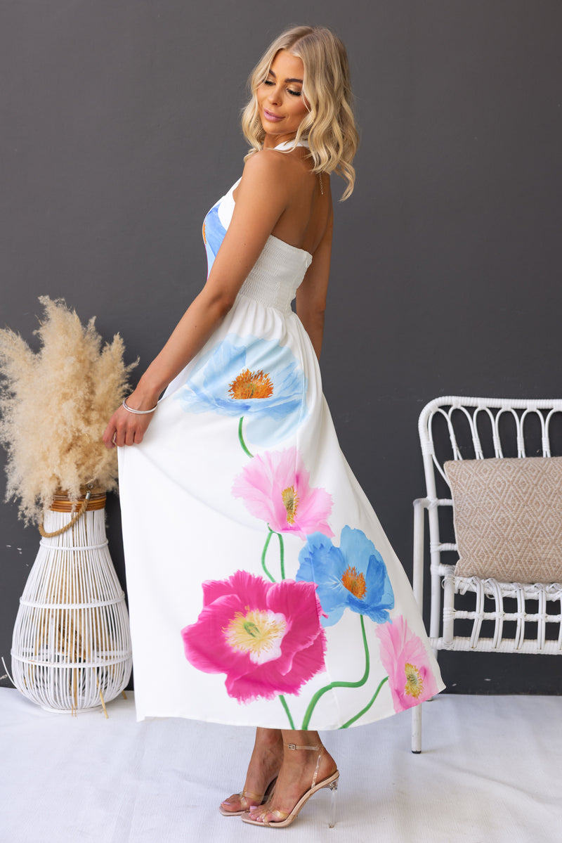 Model showcasing the Florie Maxi Dress with vibrant floral prints, featuring a button closure and elegant design.