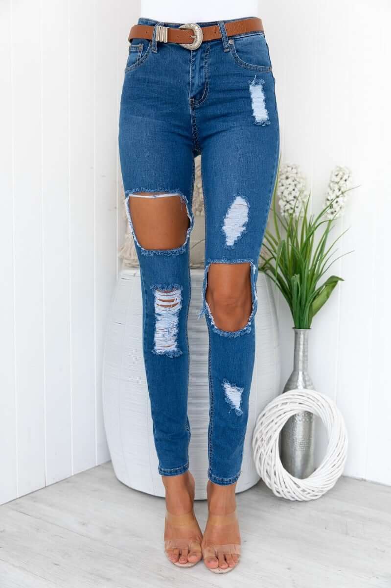 Glory Jeans: Distressed denim jeans with rip details, standard fit, and pockets for stylish casual wear.
