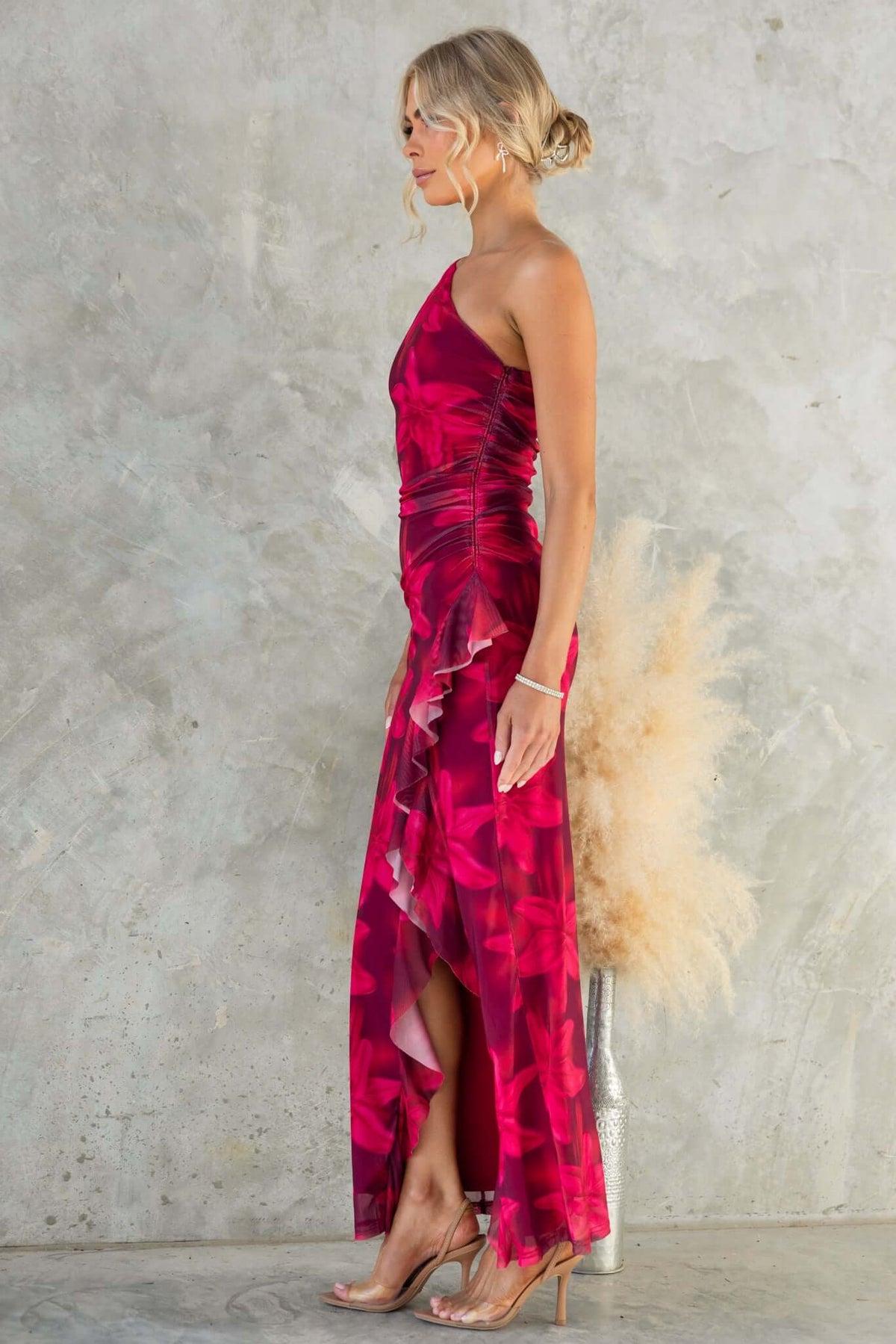 Govanna Maxi Dress in vibrant pink with one-shoulder neckline, side zip, front split, and mesh material.