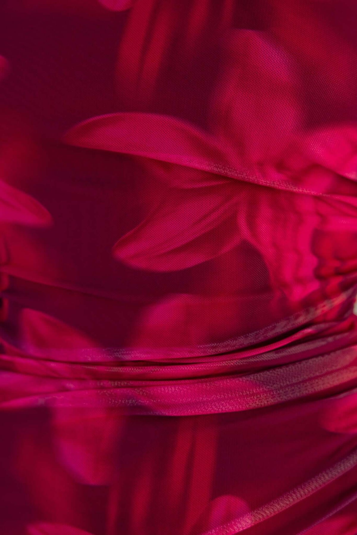 Close-up of Govanna Maxi Dress showcasing vibrant pink mesh fabric with floral print and textured detailing.