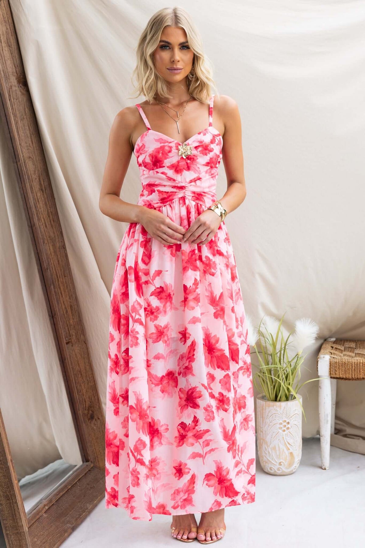 Taylah wearing the Hazelle Maxi Dress, featuring floral print, adjustable straps, and gold hardware detail.