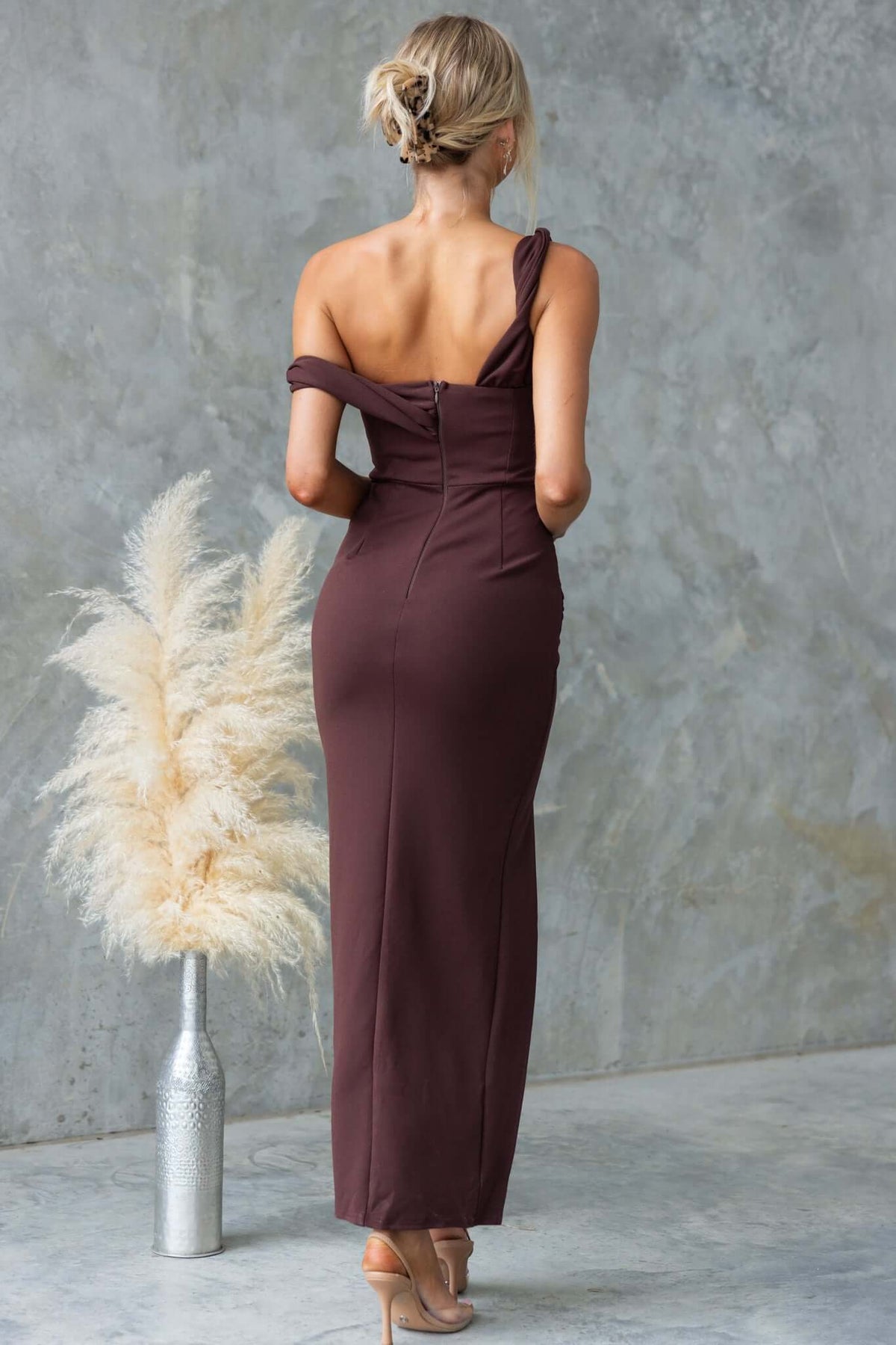 Hummer Maxi Dress in brown, featuring one-shoulder neckline, back invisible zip, and front split, shown from the back.