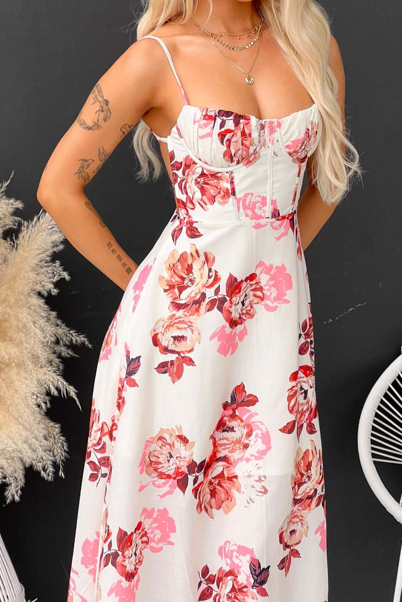 Burkes Midi Dress featuring floral print, adjustable tie straps, and a front split, modeled by a woman.