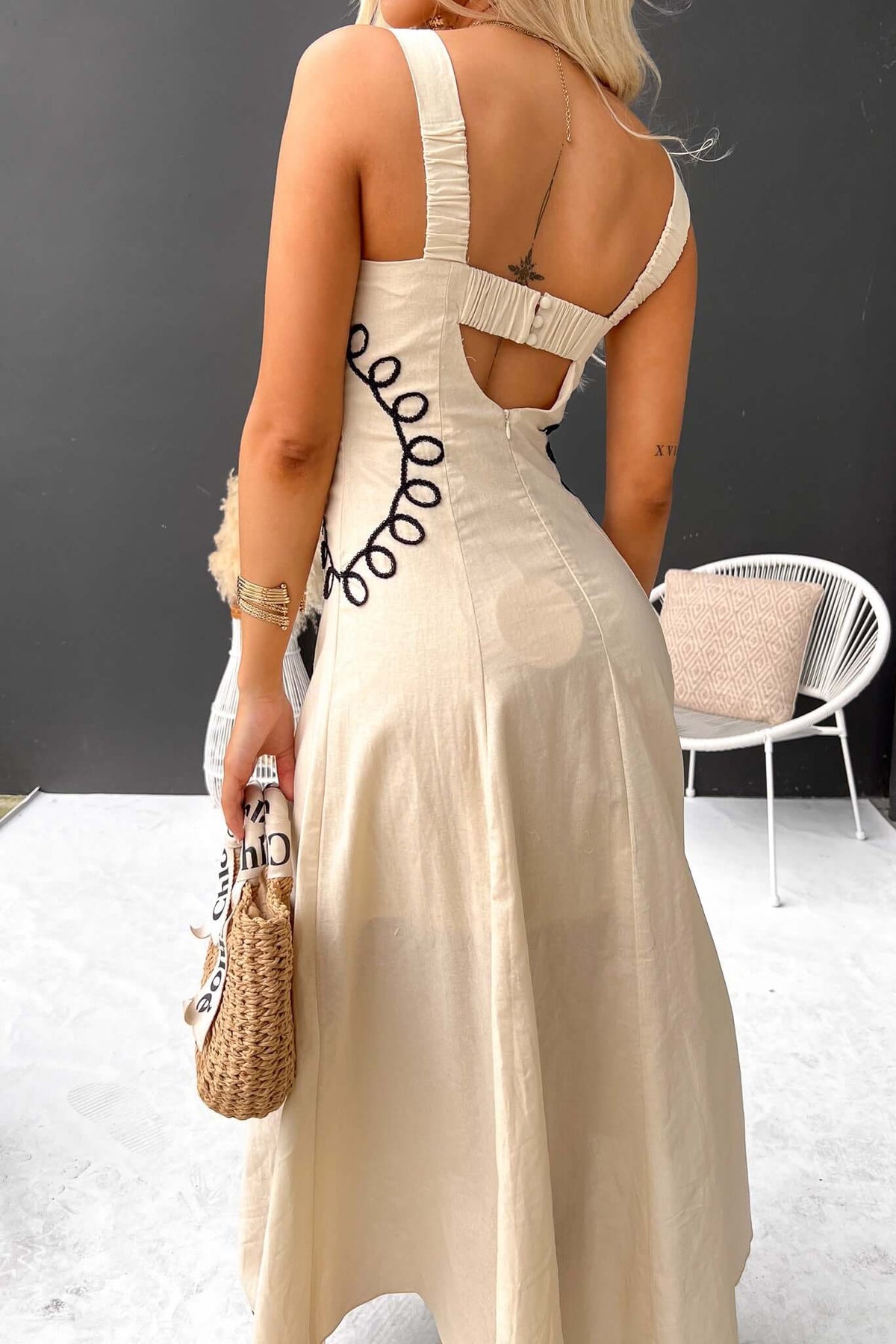 Back view of the Huckle Maxi Dress featuring elastic and button details, perfect for summer outings.