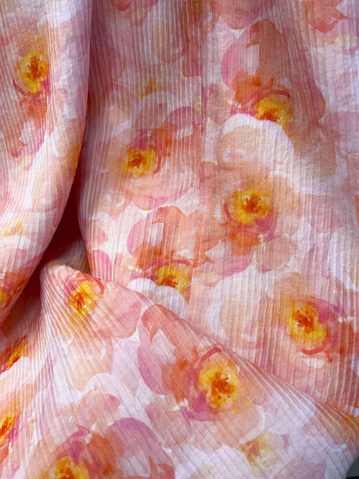 Close-up of textured fabric with peach and pink floral print, showcasing the delicate design of the Denver Maxi Dress.