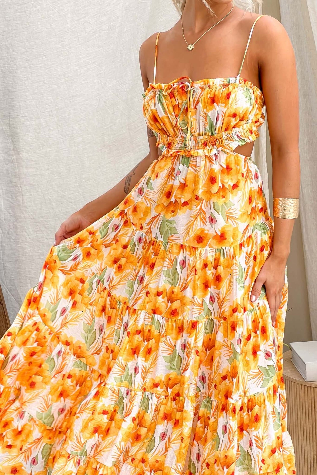 Kohana Maxi Dress featuring vibrant floral print, adjustable straps, and flowing fabric for a stylish summer look.