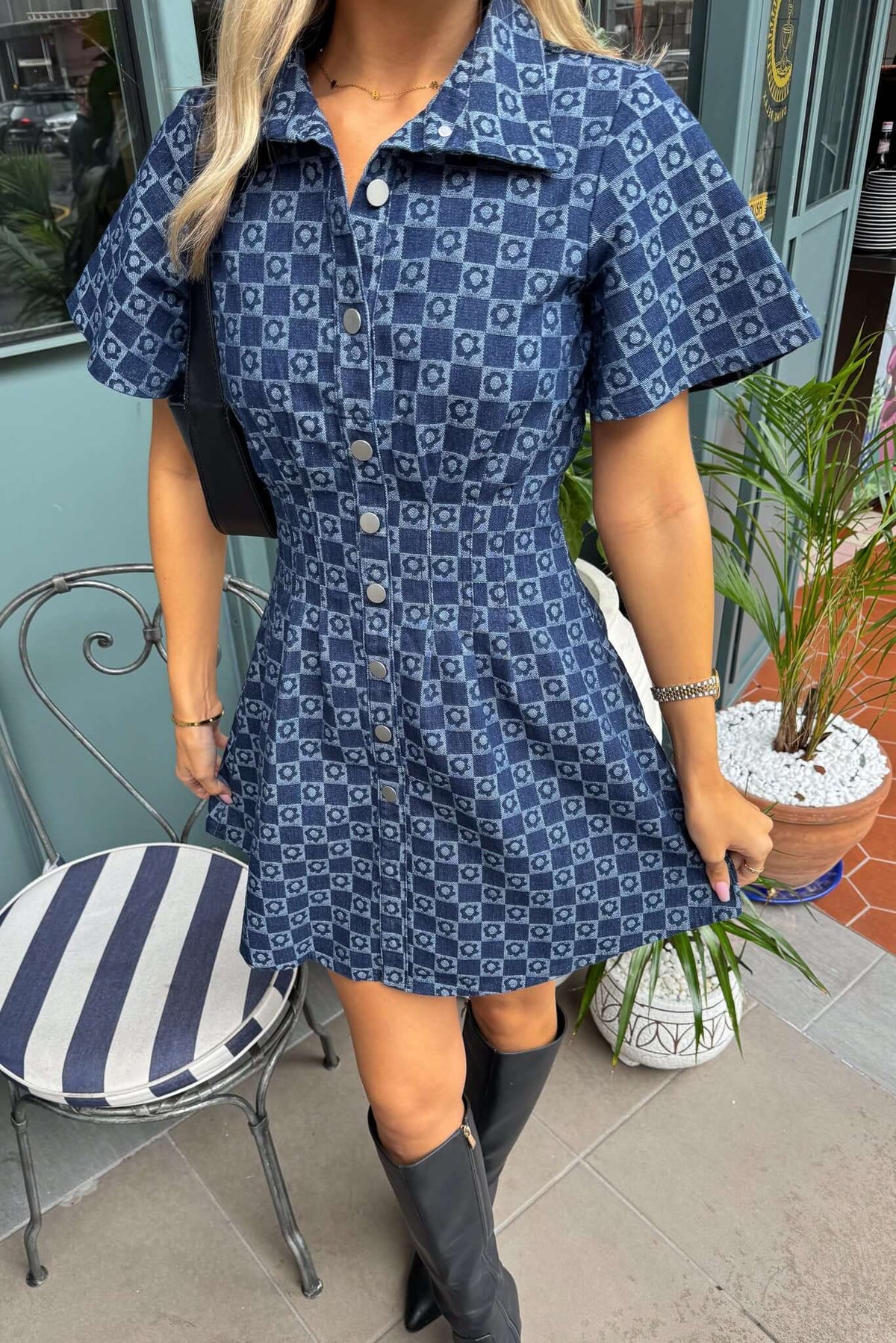 Mara Denim Dress featuring a faux button-up front, short sleeves, and classic collar, styled with knee-high boots.