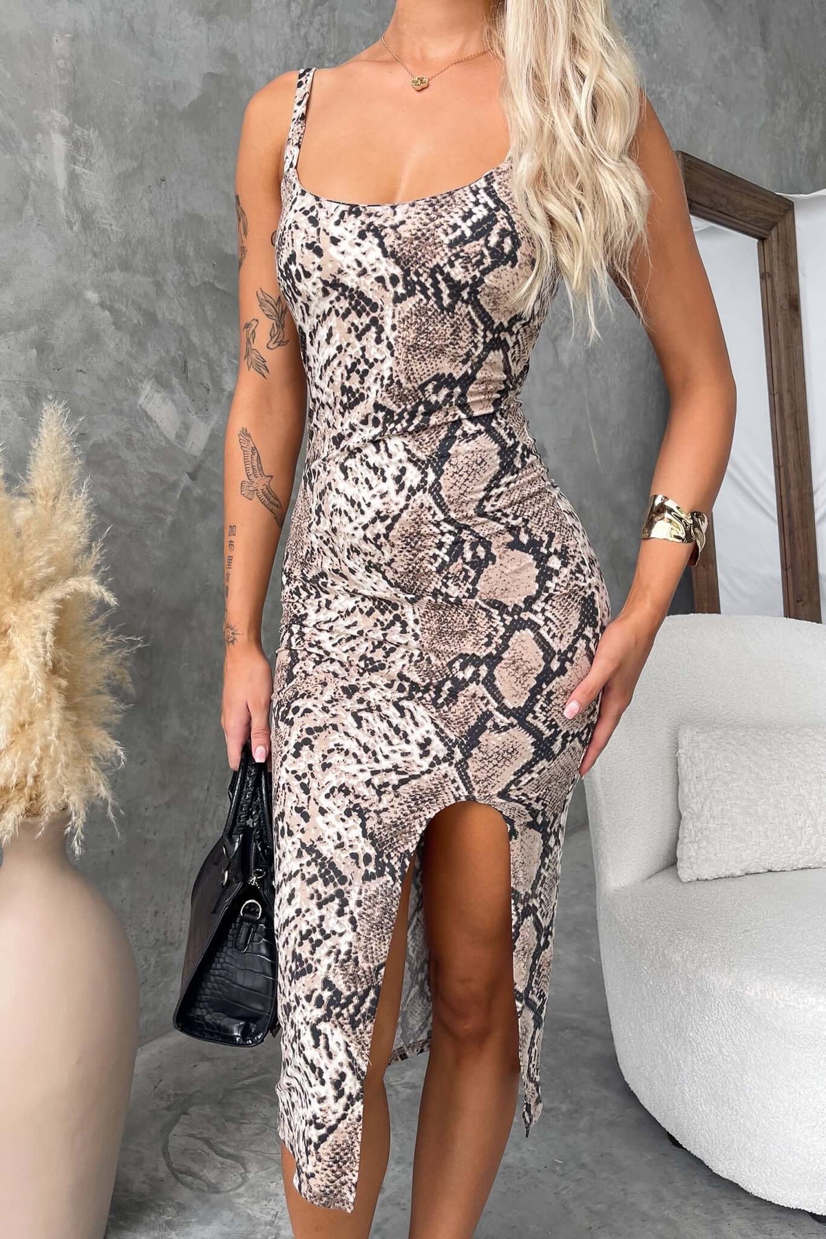 Viper Midi Dress featuring a stylish snake print, front split, and a fitted silhouette, perfect for any occasion.