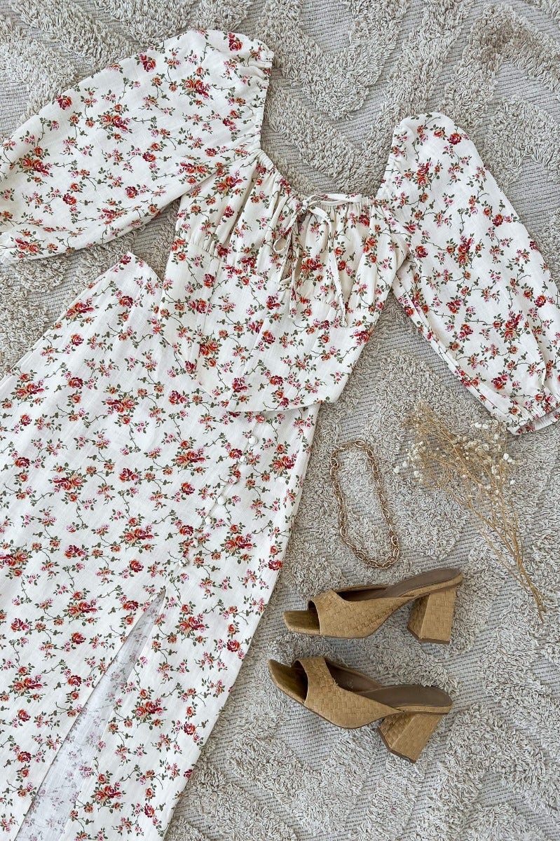 Rubie Top featuring floral design, elastic sleeves, tie detail, and paired with stylish cork block heels.