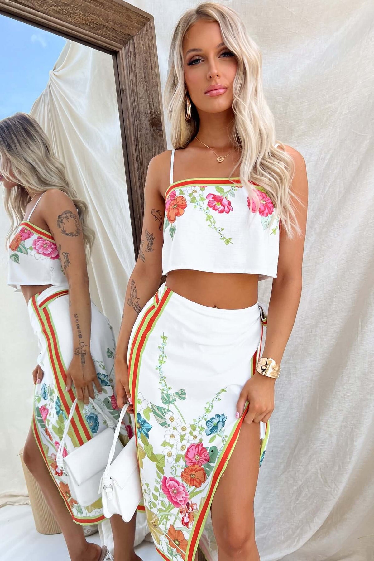 Model wearing Julissa Wrap Midi Skirt with floral print and matching crop top, showcasing a summer-ready outfit.