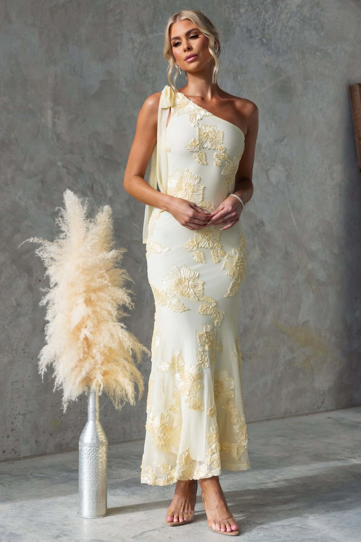 Inspire Maxi Dress featuring a one-shoulder neckline, embroidered material, and tie detail for a stylish look.